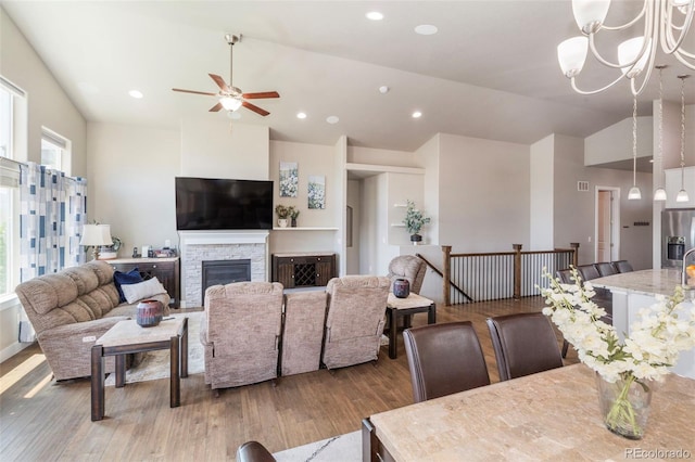 1177 Man O War Way, Colorado Springs, CO 80921 - dining area with ceiling fan, vaulted ceiling, wood-type flooring, a stone fireplace, and recessed lighting