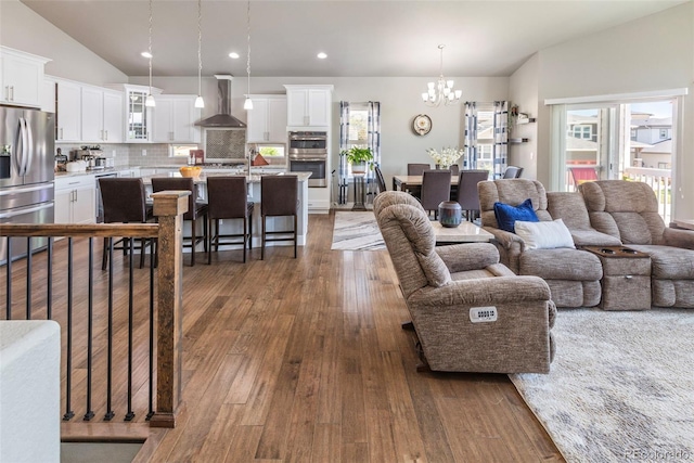 1177 Man O War Way, Colorado Springs, CO 80921 - living area featuring a chandelier, lofted ceiling, dark wood-type flooring, and recessed lighting