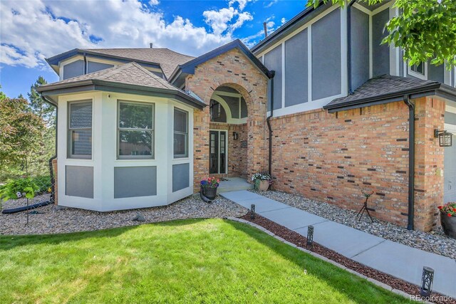 10822 Eagle Crest Ct, Parker, CO 80138 - entrance to property with a yard, a shingled roof, brick siding, and stucco siding
