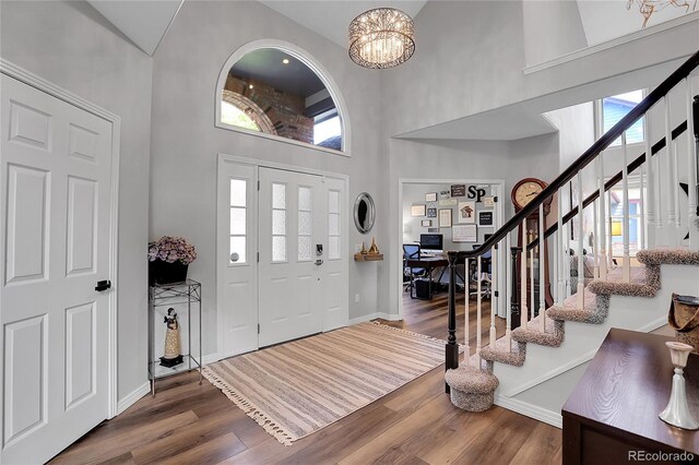 10822 Eagle Crest Ct, Parker, CO 80138 - entrance foyer featuring a towering ceiling, stairway, wood finished floors, and healthy amount of natural light