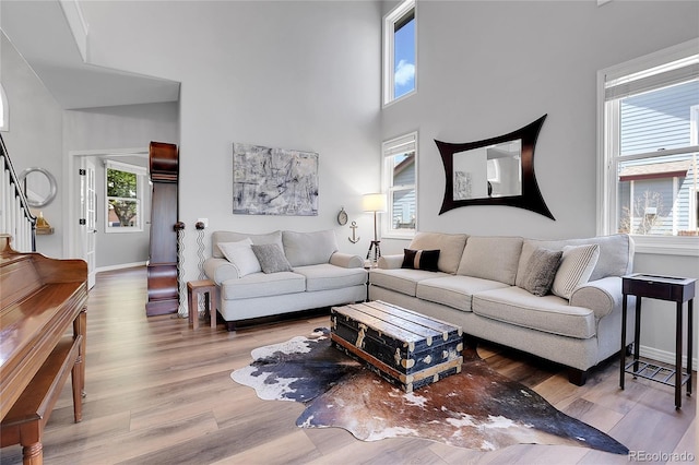 10822 Eagle Crest Ct, Parker, CO 80138 - living room with wood finished floors, a towering ceiling, and stairs
