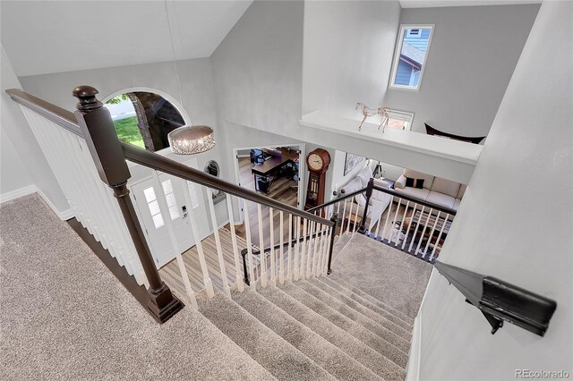 10822 Eagle Crest Ct, Parker, CO 80138 - stairway featuring carpet and high vaulted ceiling