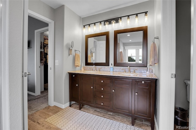 10822 Eagle Crest Ct, Parker, CO 80138 - full bathroom with wood finished floors, double vanity, and a spacious closet