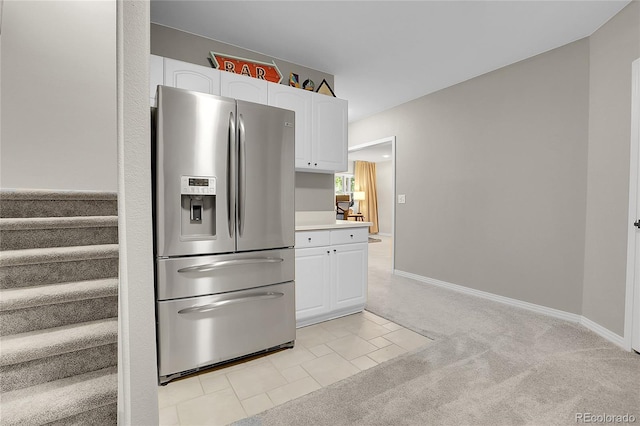 10822 Eagle Crest Ct, Parker, CO 80138 - kitchen with stainless steel refrigerator with ice dispenser, white cabinetry, light countertops, and light colored carpet