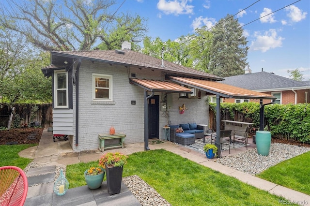 1870 S Ogden St, Denver, CO 80210 - back of house with brick siding, a patio, an outdoor hangout area, and a chimney
