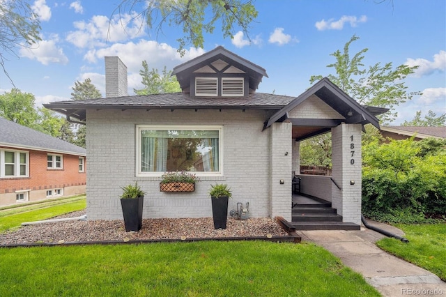 1870 S Ogden St, Denver, CO 80210 - bungalow-style home featuring brick siding, a chimney, and a front yard