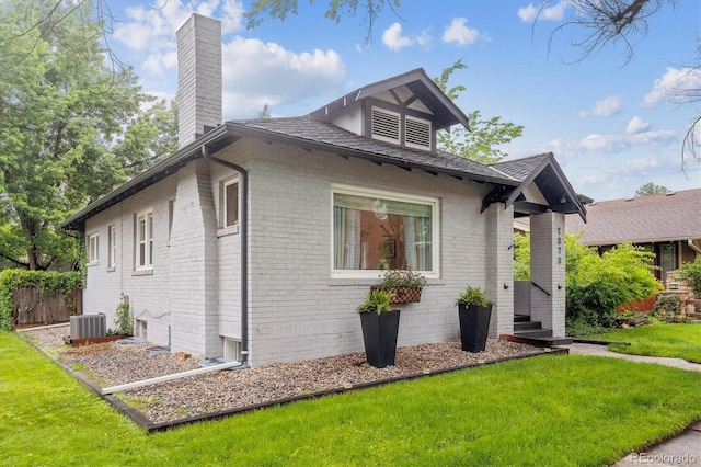 1870 S Ogden St, Denver, CO 80210 - view of front of property with a chimney, brick siding, and central air condition unit