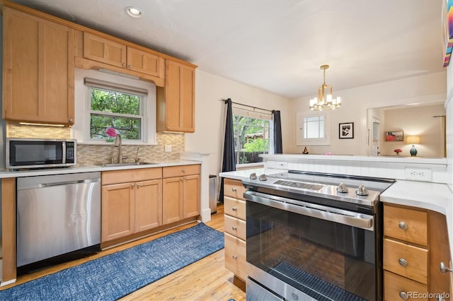 1870 S Ogden St, Denver, CO 80210 - kitchen with appliances with stainless steel finishes, a sink, light countertops, a chandelier, and recessed lighting