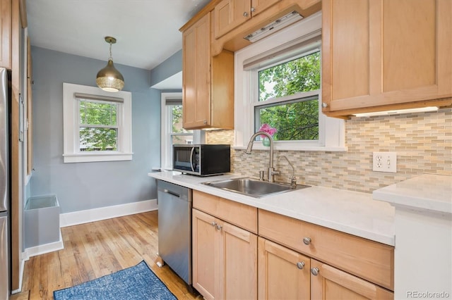 1870 S Ogden St, Denver, CO 80210 - kitchen featuring dishwasher, a sink, light brown cabinets, baseboards, and backsplash