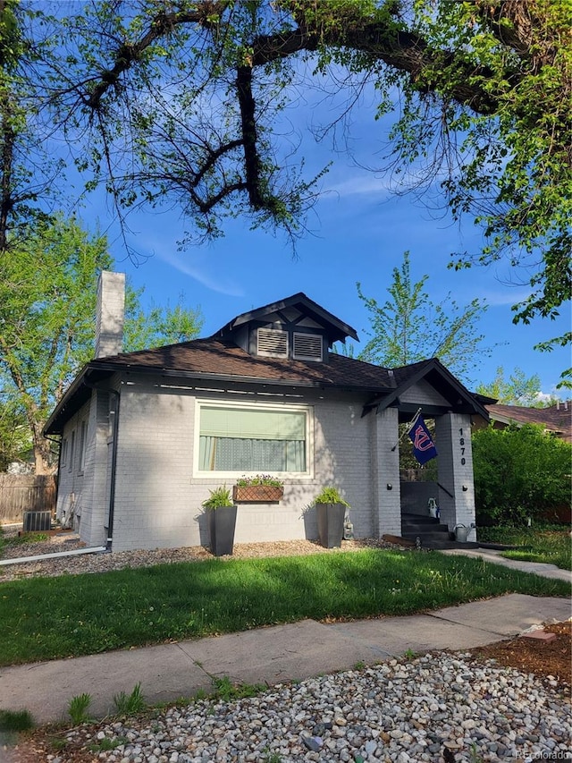 1870 S Ogden St, Denver, CO 80210 - view of front of house featuring a chimney, brick siding, and central AC unit