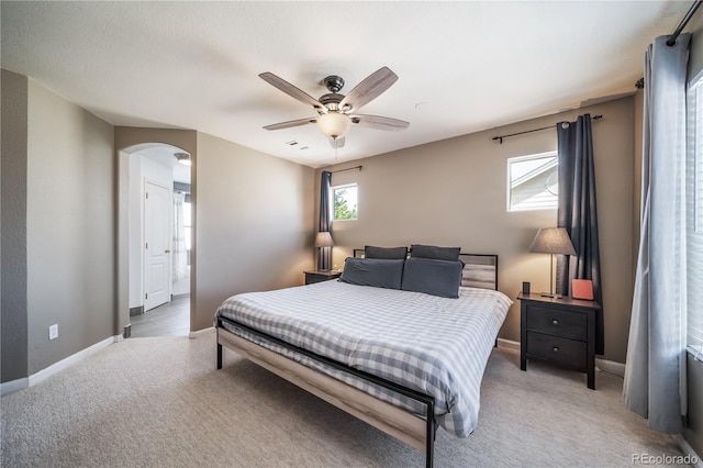 13152 E 104th Dr, Commerce City, CO 80022 - bedroom featuring light carpet, arched walkways, and ceiling fan