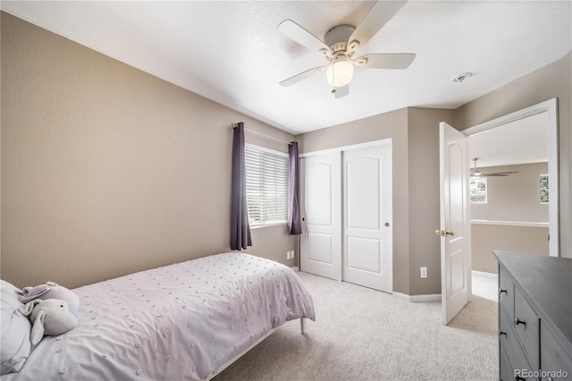 13152 E 104th Dr, Commerce City, CO 80022 - bedroom with multiple windows, a closet, light colored carpet, and a ceiling fan