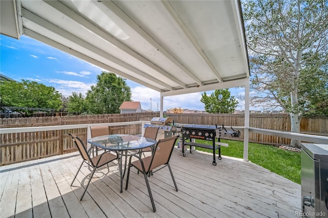 13152 E 104th Dr, Commerce City, CO 80022 - wooden terrace with outdoor dining space and a fenced backyard
