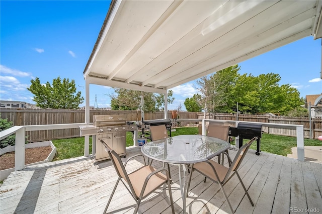 13152 E 104th Dr, Commerce City, CO 80022 - wooden terrace with area for grilling, outdoor dining space, and a fenced backyard