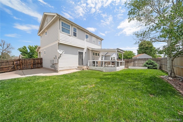 13152 E 104th Dr, Commerce City, CO 80022 - rear view of house featuring a fenced backyard, a patio area, and a wooden deck