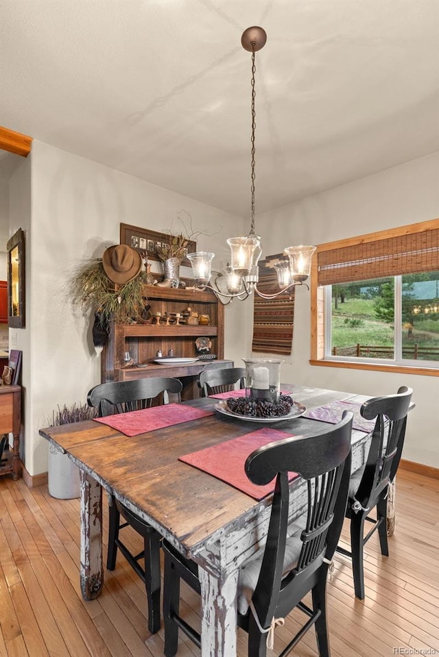 15608 Ouray Rd, Pine, CO 80470 - dining area with light wood-style flooring and a chandelier