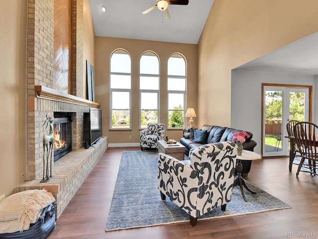 2145 Wynterbrook Dr, Highlands Ranch, CO 80126 - living area with a ceiling fan, high vaulted ceiling, plenty of natural light, a fireplace, and wood finished floors