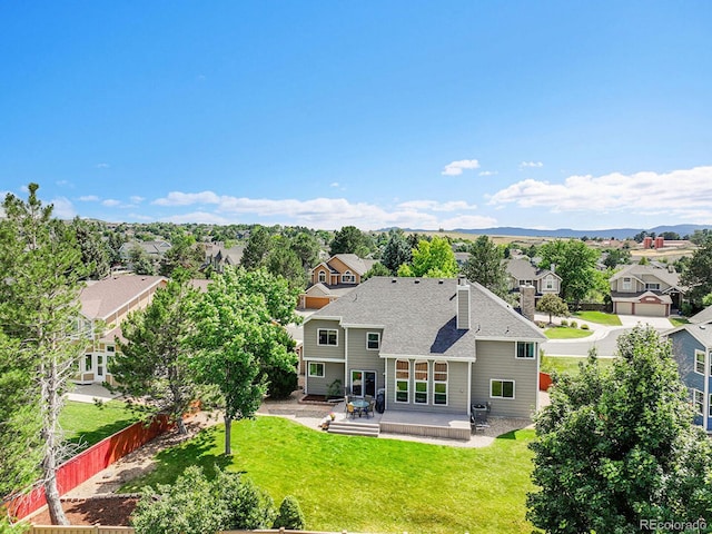 2145 Wynterbrook Dr, Highlands Ranch, CO 80126 - back of property featuring a residential view, a patio area, a shingled roof, and a chimney