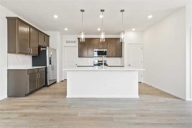 kitchen featuring stainless steel appliances, dark brown cabinetry, light countertops, backsplash, and recessed lighting