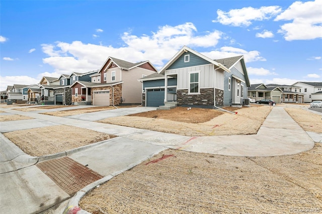 view of property with board and batten siding, a residential view, driveway, and stone siding