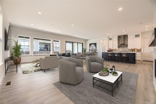 living room with light wood-type flooring and a wealth of natural light