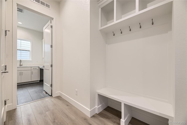 mudroom featuring light wood-type flooring and sink