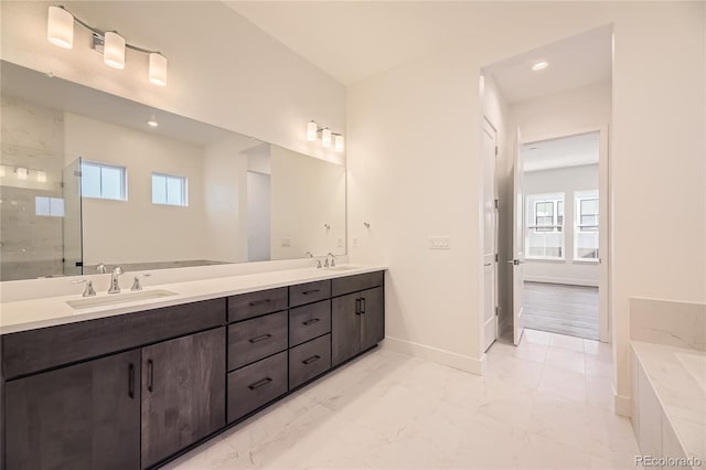 bathroom featuring walk in shower, vanity, and a wealth of natural light