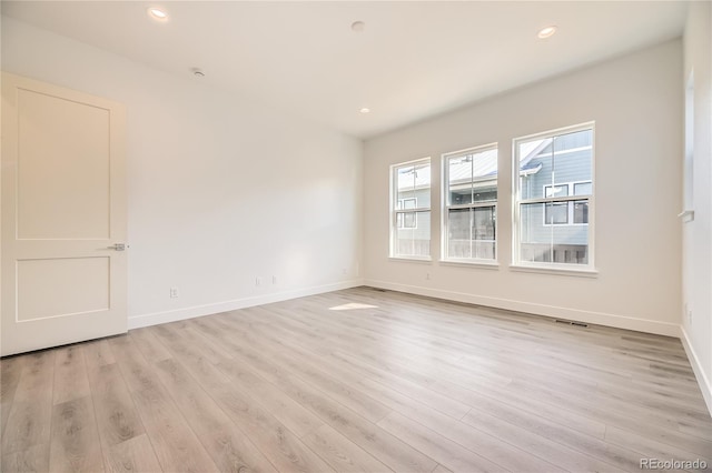 unfurnished room featuring light hardwood / wood-style floors