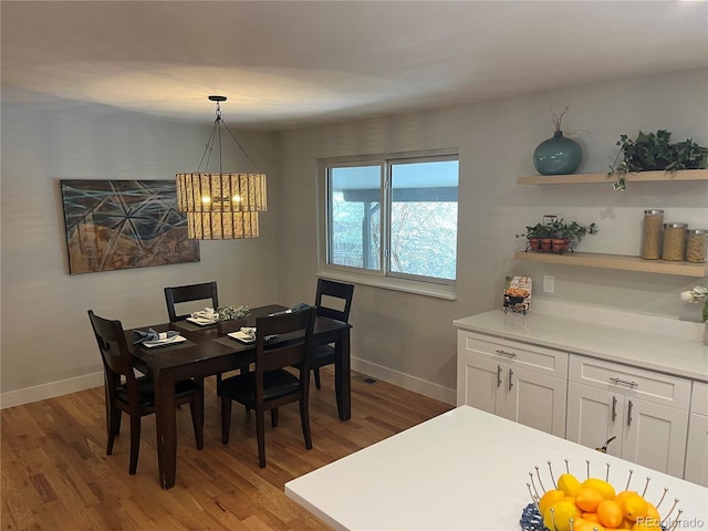 9705 W Dakota Ave, Lakewood, CO 80226 - dining area with wood finished floors, baseboards, and a notable chandelier