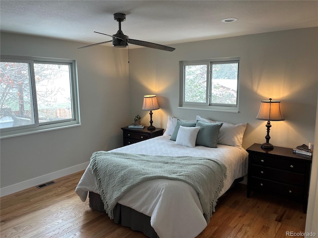 9705 W Dakota Ave, Lakewood, CO 80226 - bedroom with baseboards, multiple windows, visible vents, and wood finished floors