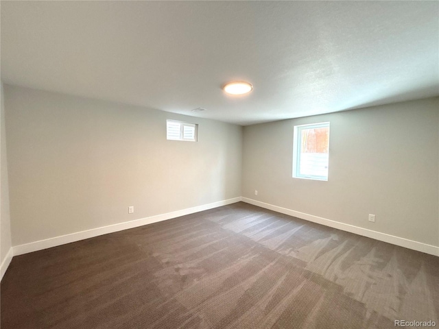 9705 W Dakota Ave, Lakewood, CO 80226 - below grade area with baseboards, dark carpet, and plenty of natural light
