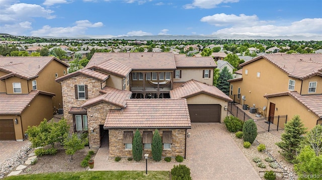 9487 Winding Hill Way, Lone Tree, CO 80124 - view of front of home with a tile roof, stucco siding, a residential view, a garage, and stone siding