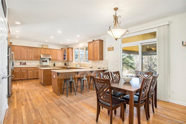 dining room with baseboards, recessed lighting, and light wood-style floors