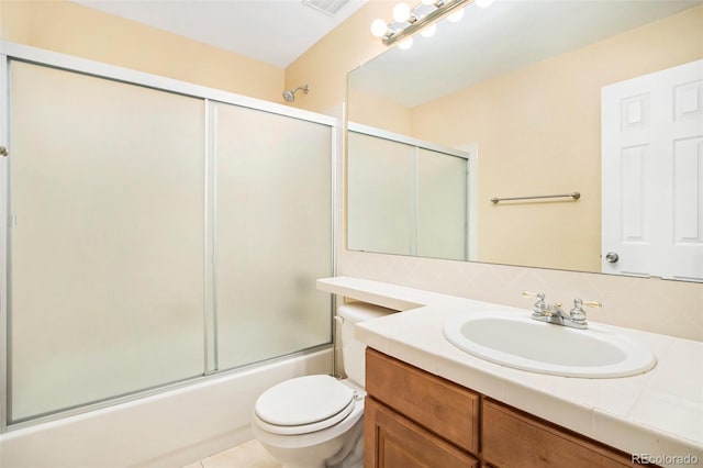 full bath with visible vents, bath / shower combo with glass door, toilet, tile patterned flooring, and vanity