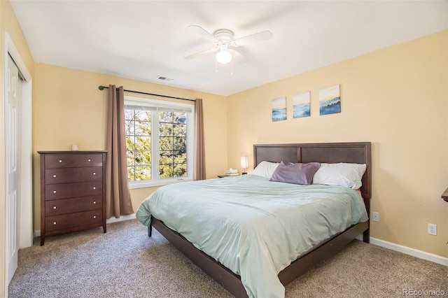 bedroom featuring ceiling fan, carpet flooring, visible vents, and baseboards