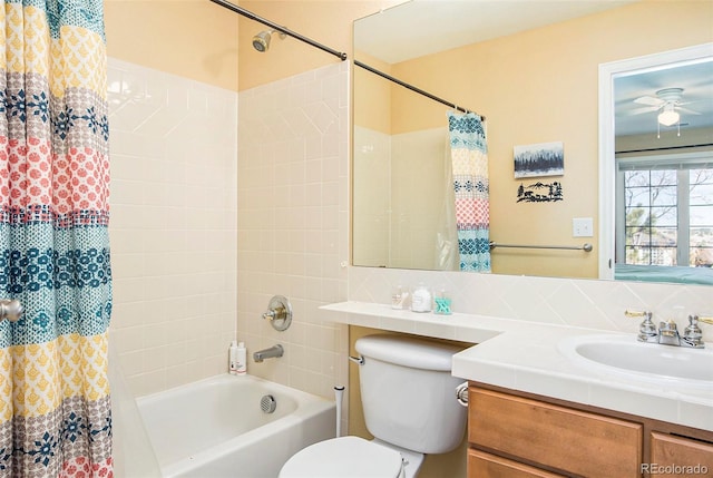 bathroom with toilet, shower / bathtub combination with curtain, a ceiling fan, and vanity