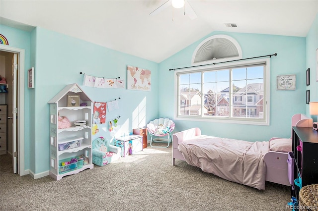 carpeted bedroom featuring a ceiling fan, visible vents, and vaulted ceiling