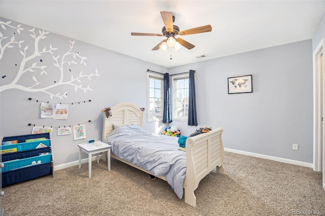 carpeted bedroom featuring visible vents, baseboards, and a ceiling fan