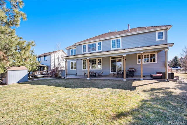 back of house with a patio area, a storage unit, a lawn, and an outdoor structure