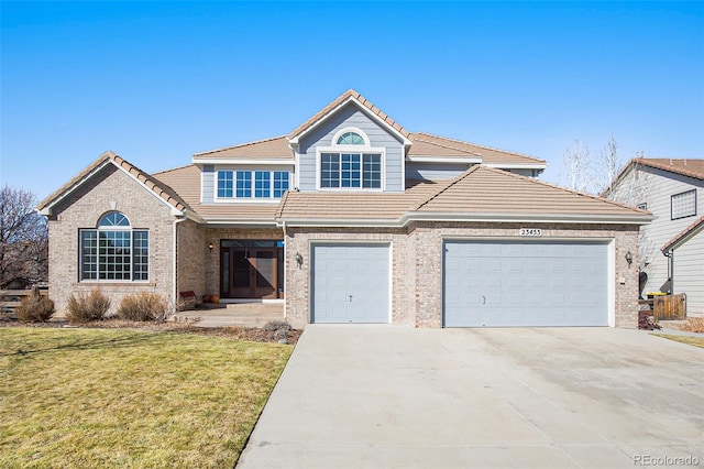 traditional-style house featuring concrete driveway, a tile roof, and brick siding