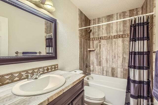 3143 50th Avenue Ct, Greeley, CO 80634 - full bath with a textured wall, vanity, and shower / tub combo with curtain