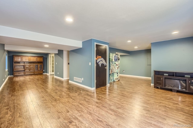 3143 50th Avenue Ct, Greeley, CO 80634 - unfurnished living room with wood finished floors and recessed lighting