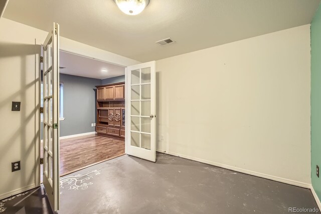 3143 50th Avenue Ct, Greeley, CO 80634 - spare room with french doors and finished concrete floors