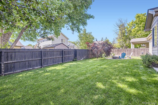 3143 50th Avenue Ct, Greeley, CO 80634 - fenced backyard with a fire pit