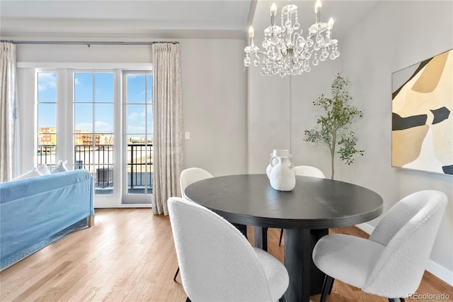 dining room with a notable chandelier and light hardwood / wood-style floors