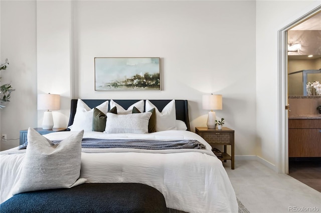 carpeted bedroom featuring ensuite bathroom