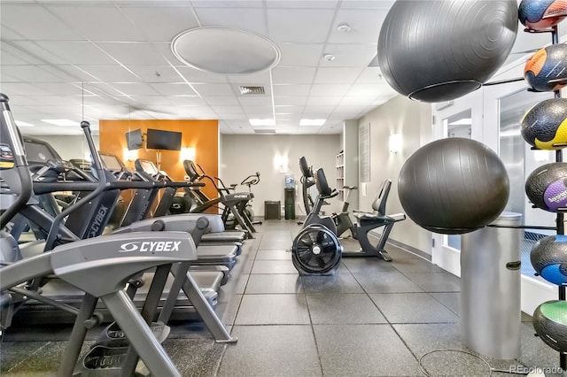 gym with a paneled ceiling