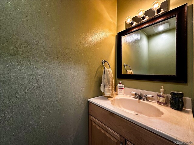 10753 Routt Ct, Broomfield, CO 80021 - bathroom featuring a textured wall and vanity