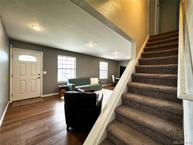 10753 Routt Ct, Broomfield, CO 80021 - stairs featuring recessed lighting, wood finished floors, and baseboards