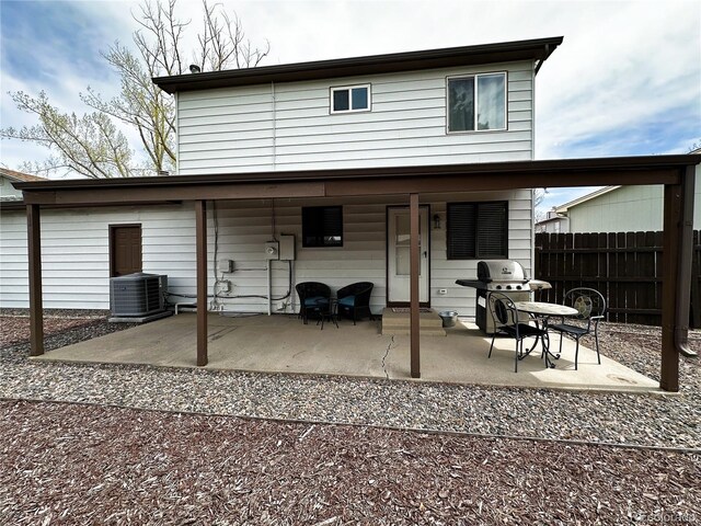 10753 Routt Ct, Broomfield, CO 80021 - rear view of property featuring central AC, fence, and a patio area